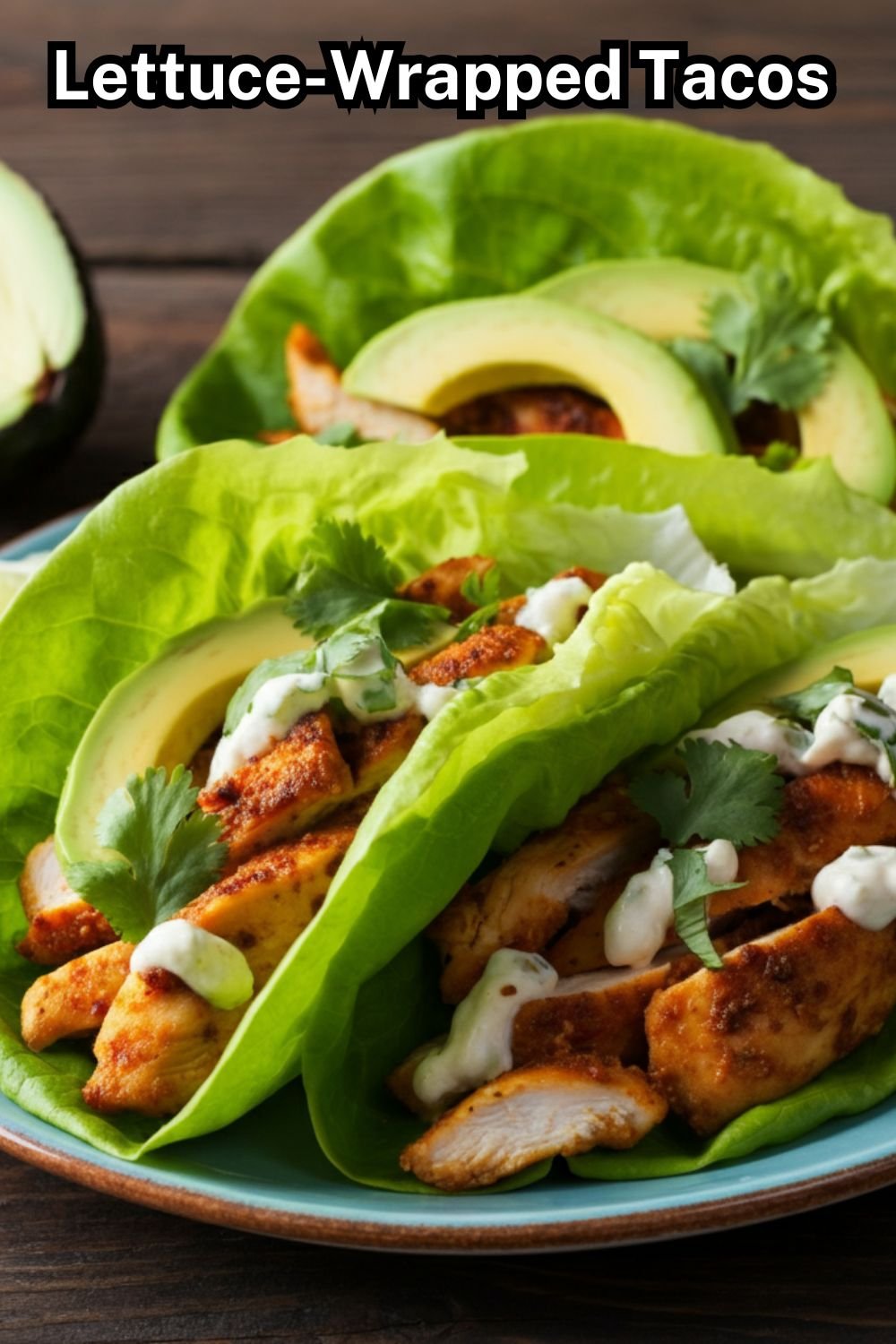 A vibrant plate of lettuce-wrapped tacos displayed on a wooden tabletop. Each taco is filled with grilled chicken, fresh avocado slices, and topped with a drizzle of creamy lime sauce. Garnished with lime wedges and a sprinkle of chopped cilantro.