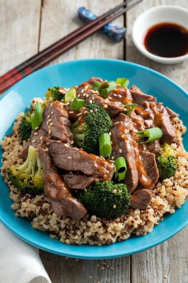 A vibrant plate of stir-fried beef and broccoli glistening with garlic sauce, served over a fluffy bed of quinoa. Garnish with a sprinkle of sesame seeds and sliced green onions. Set on a rustic wooden table with chopsticks and a small bowl of soy sauce on the side. 